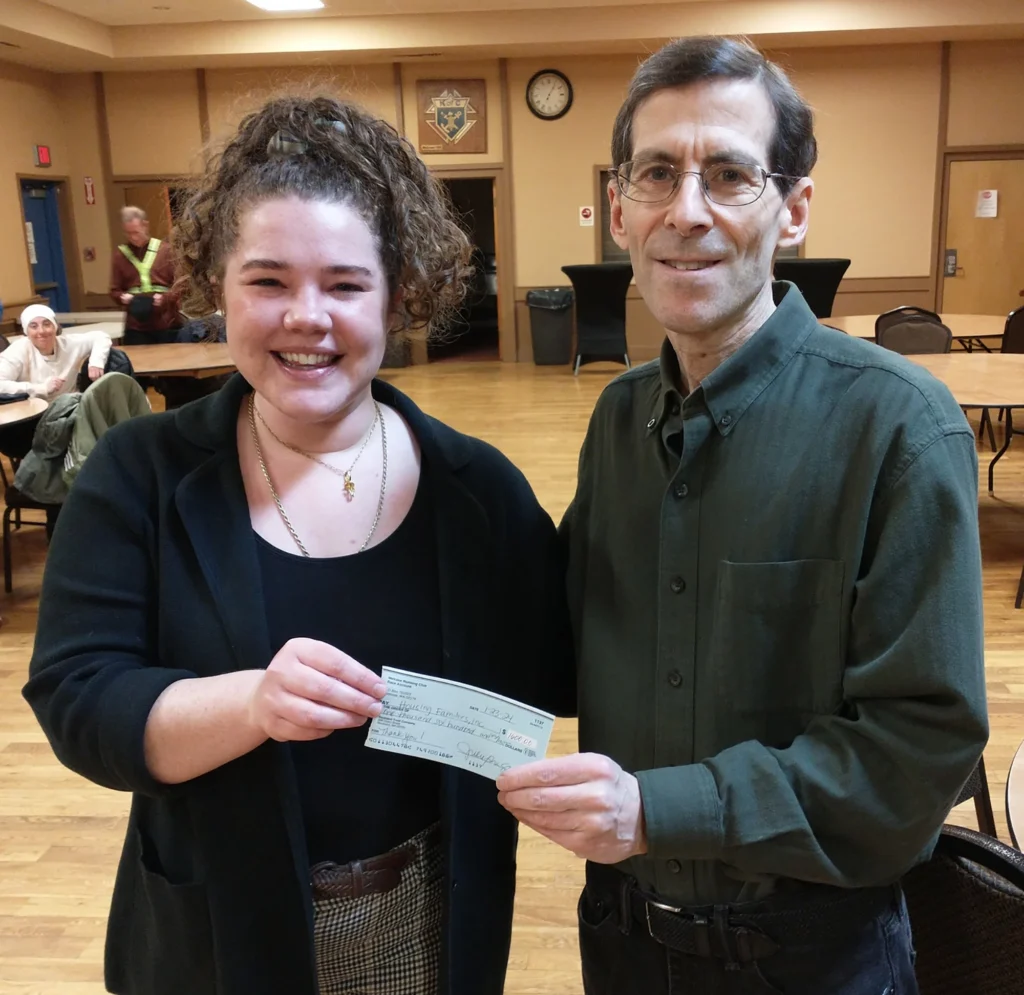 People holding a check donation to Housing Families